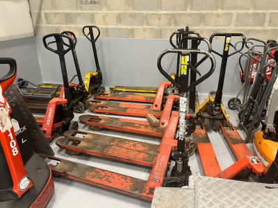a lot of forklifts that are lined up in a room