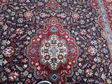 someone is standing in front of a large oriental rug on the floor