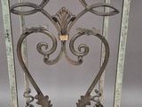 wrought iron table with a glass top on a wooden floor