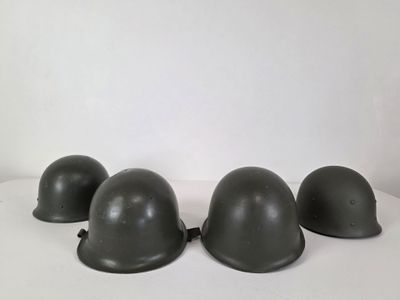 three helmets are lined up on a white surface