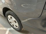 a close up of a car ' s tire on the side of the road