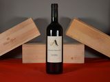 a bottle of wine sitting on a table next to two wooden boxes