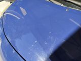 a close up of a car ' s hood with the hood down