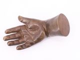 a bronze statue of a hand holding a cup