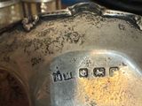 a close up of a silver plate with a clock on it