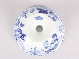 a blue and white bowl with a flower design on it