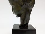 bronze head of a young boy on a black base