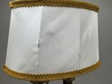 a lamp that has a white shade on top of it