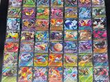 a large collection of pokemon cards are displayed on a table
