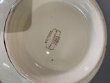 a close up of a white bowl with a brown label on it