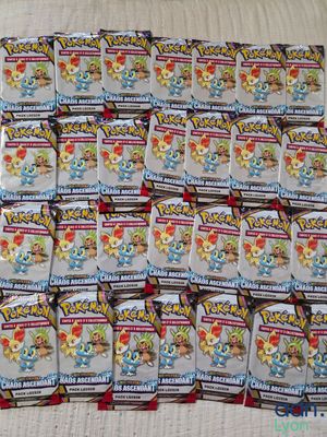 a pile of pokemon trading cards sitting on top of a table