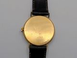 an image of a gold plated wrist watch with black leather strap