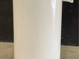 an image of a white water tank sitting on top of a cement floor