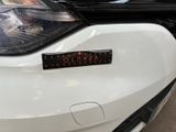 a close up of a car ' s headlight with a sticker on it