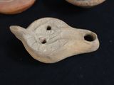 some old pottery items are sitting on a black surface