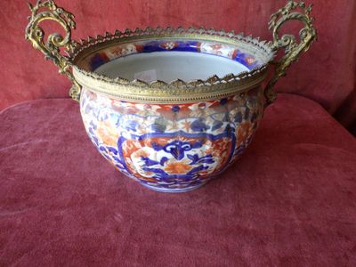 a large vase that is sitting on a red couch