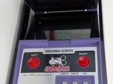 purple and black nintendo game console sitting on top of a white table