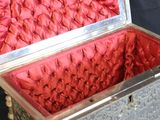a silver box with red flowers in it on a black background