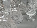 a lot of glassware on a table with a glass bowl
