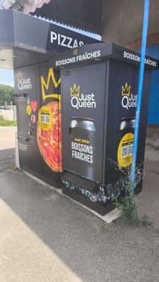 un graffiti sur le mur d'un immeuble faisant la promotion d'une pizzeria
