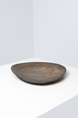 a close up of a wooden plate on a white surface