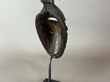 sculpture of a bird on a shell on a black stand