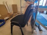 a chair that is sitting in a room with boxes on the floor