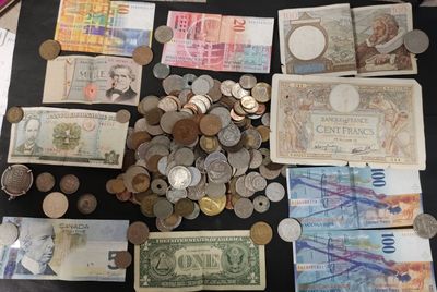 a lot of money on a table with a lot of coins
