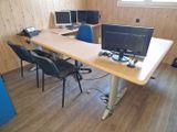 a desk with two computer monitors and a laptop on it