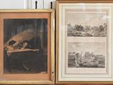 two framed pictures of a man sitting at a desk