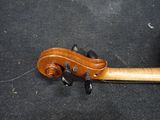 a violin that is laying on a black surface