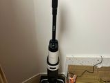 a vacuum that is sitting on the floor next to a box