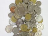 a pile of coins sitting on a white surface