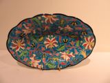 a blue bowl with a floral design on it on a table