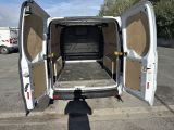 a white van with its doors open in a parking lot