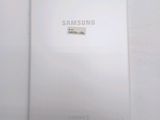 the back of a white samsung tablet with a sticker on it