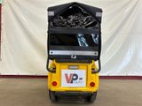 a small cart with a pile of garbage in it