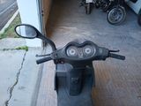 a scooter that is parked in front of a garage