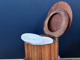 a wooden stool with a marble top on a hard wood floor