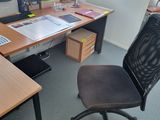 a desk with a chair and a computer on it