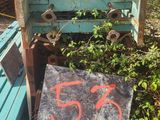 a sign on the ground next to a pile of junk