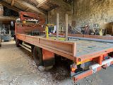 a truck that is sitting in a garage with a lot of tools