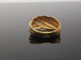 an image of a gold ring on a black surface