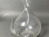 a clear glass vase with a cat inside of it