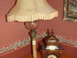a table with a lamp and a clock on it