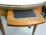 a wooden table with a black and white placemat on it