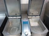 two stainless steel sinks in a public restroom