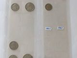 two bags of coins are sitting on a table with labels on them