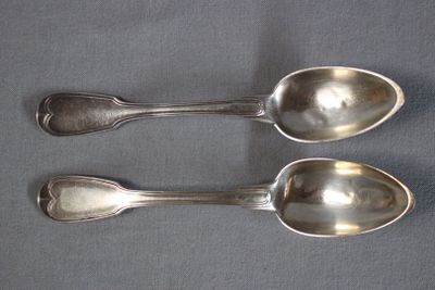 two spoons sitting next to each other on a table