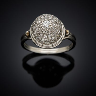 a close up of a diamond ring on a black surface